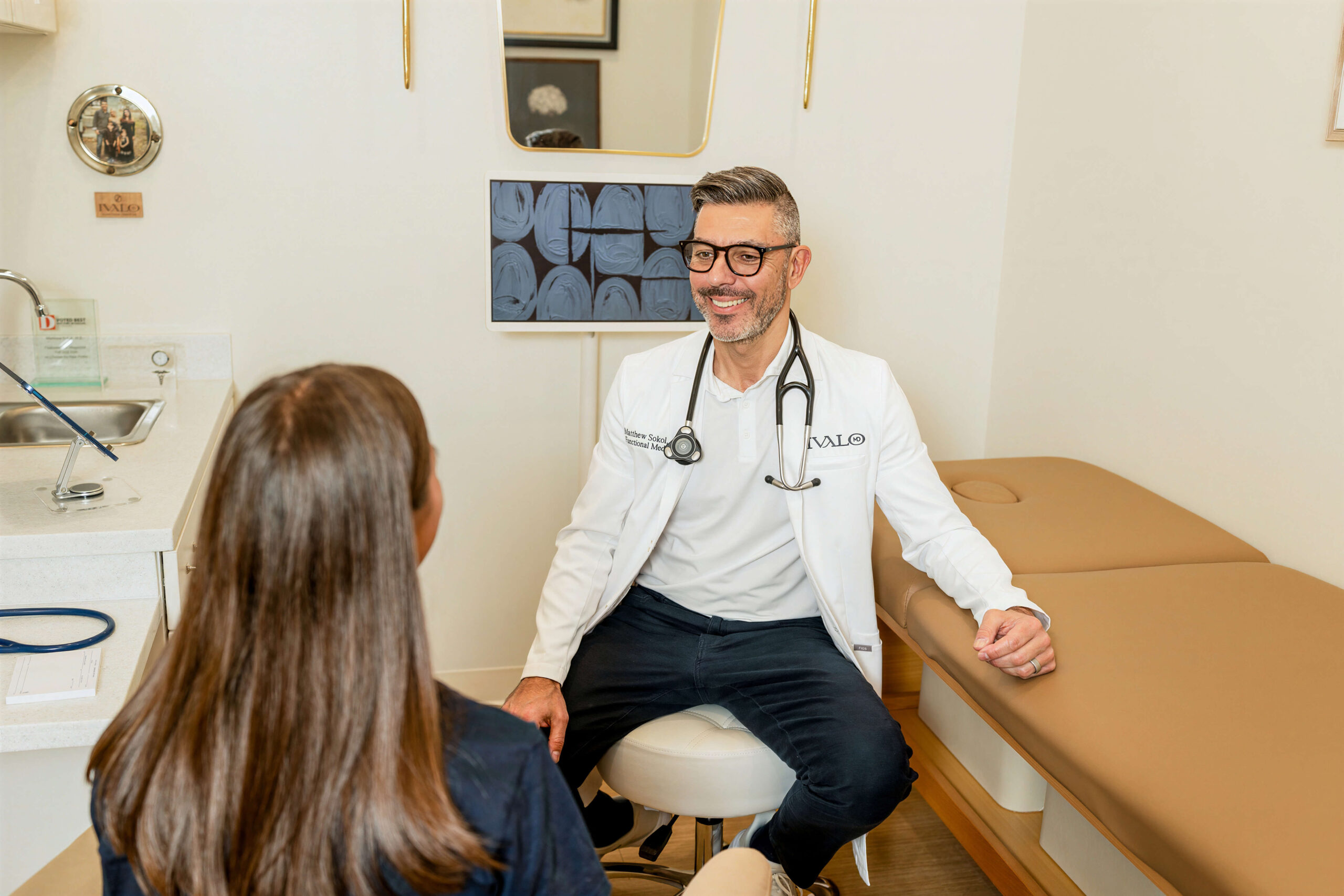 Dr. Sokol meeting with a patient in a private exam room at Ivalo MD in McKinney